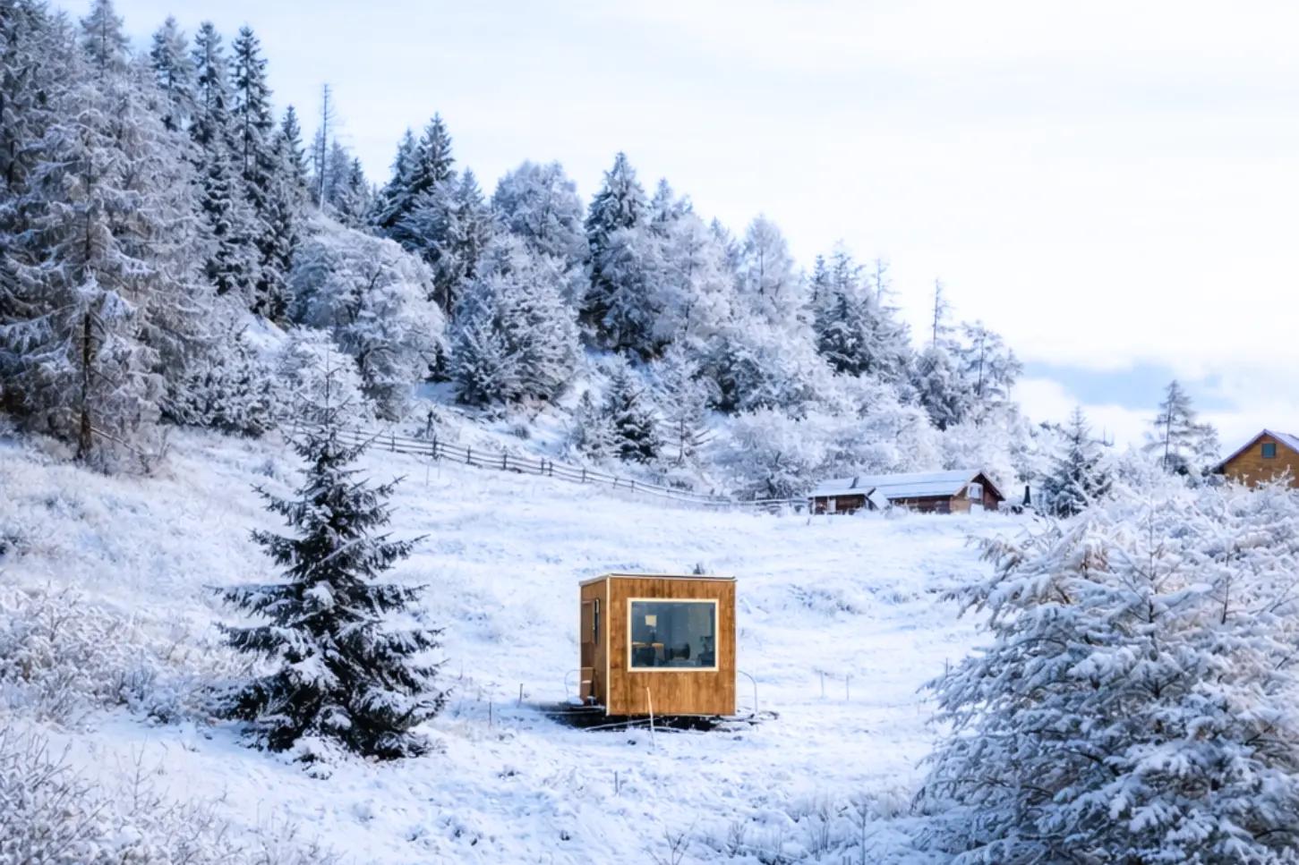 Friland house under the snow in the Dolomites at Cima Lan near Arsie